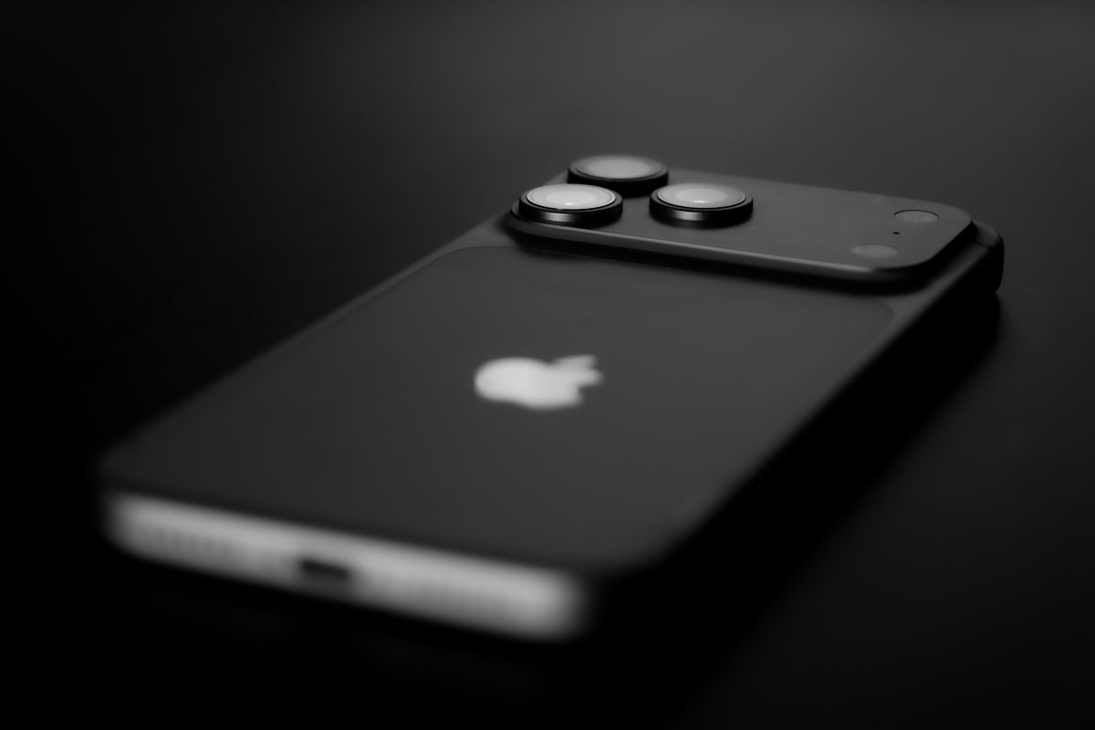 Black smartphone with three camera lenses on back