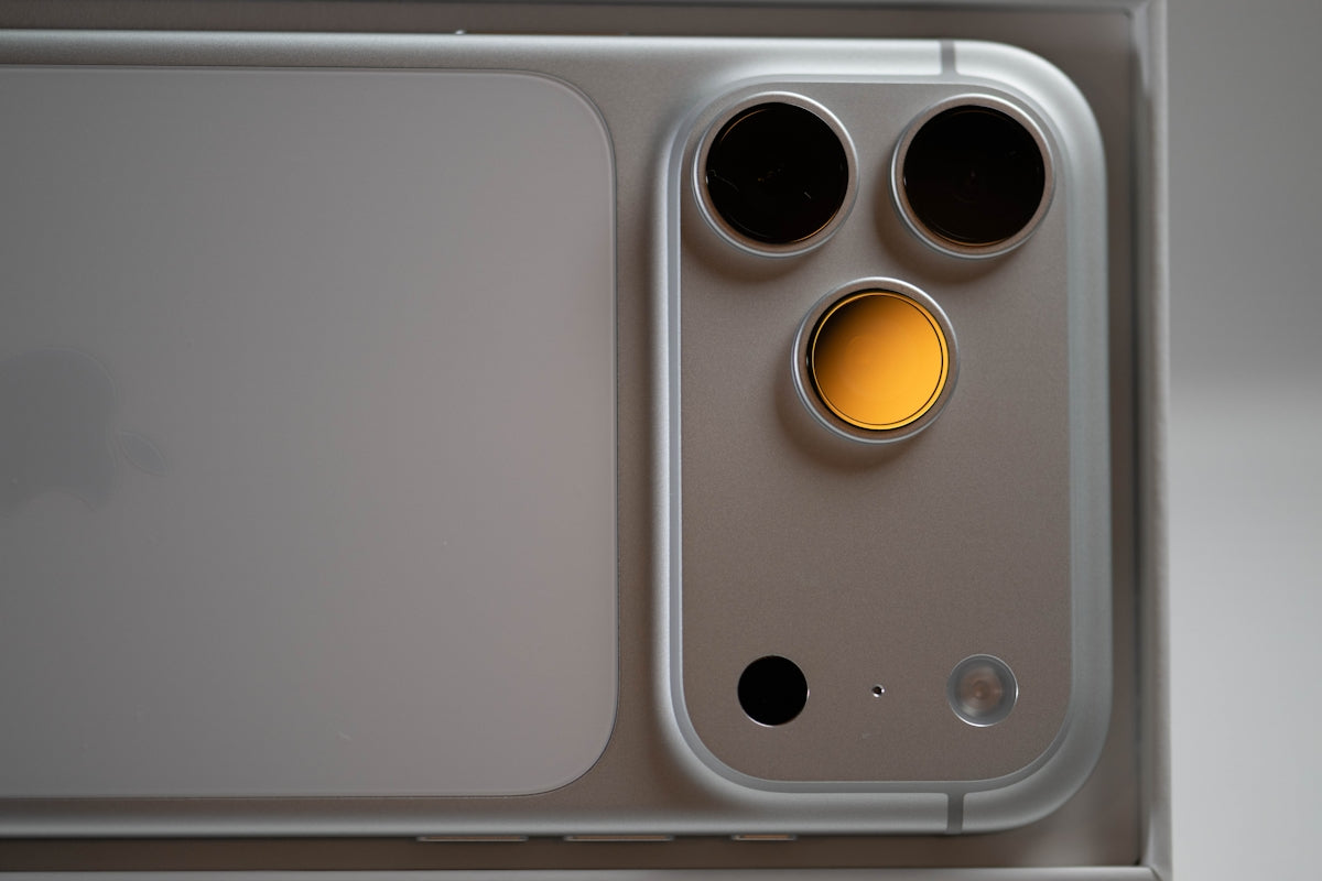 Close-up of a silver smartphone camera module.