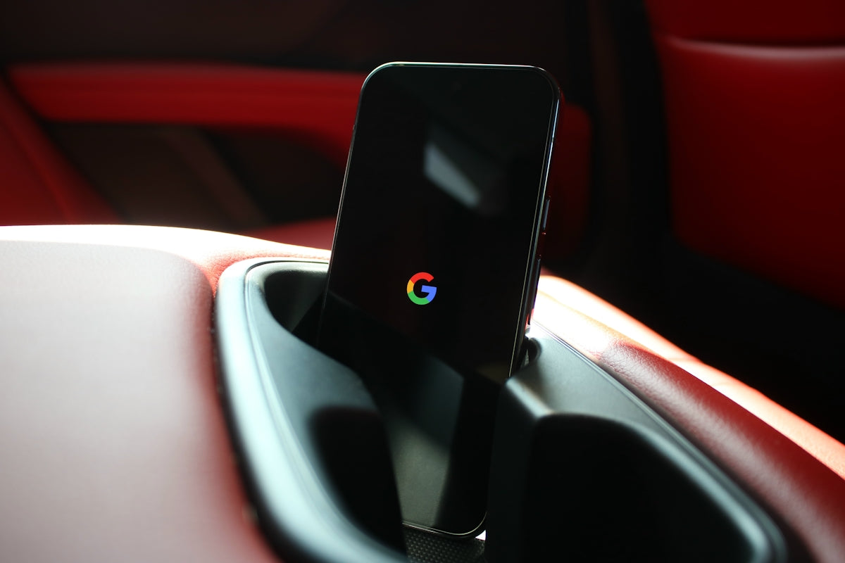 A cell phone in a holder in a car